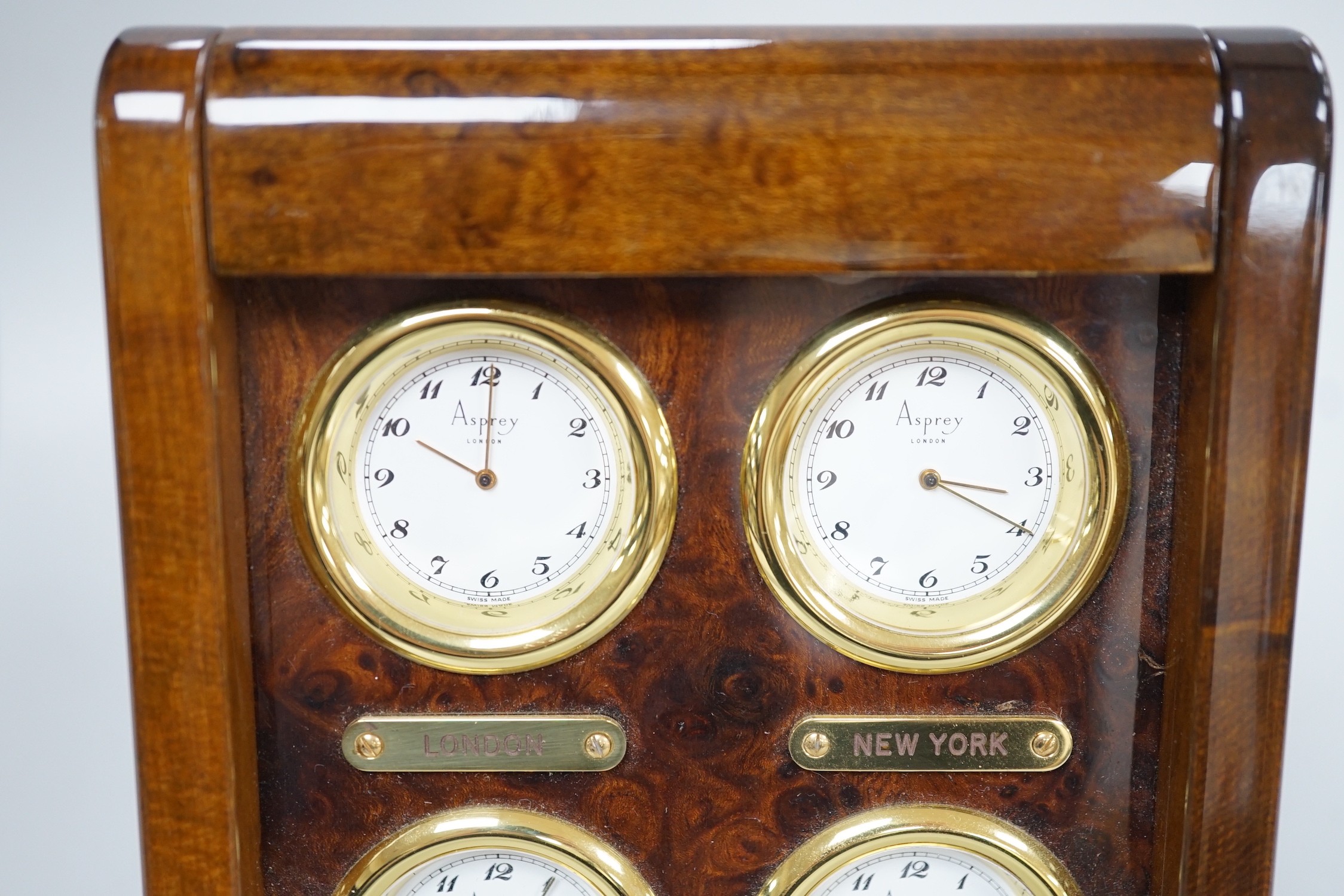 An Asprey burr wood veneered desktop four time zone timepiece, 15.5 cm